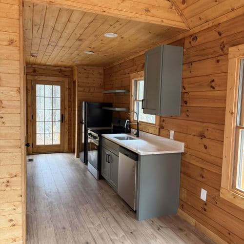 Compact cabin kitchen with gray cabinetry